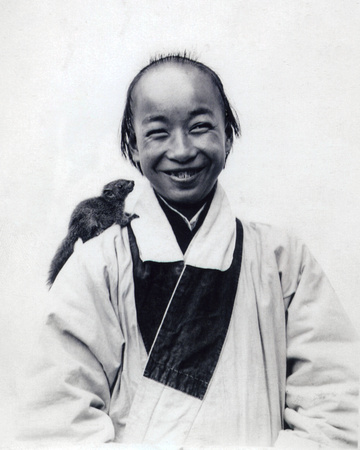 Young Daoist monk with pet squirrel (undated, presumably 1920s)