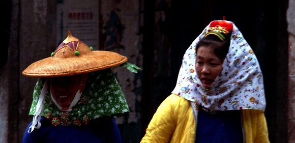Women partially "veiled" and wearing straw hat