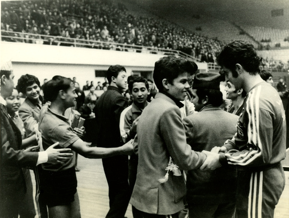 Athletes from Nepal warmly shaking hands with players and coaches after the match