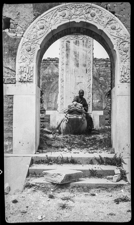Beggar at entrance [to] Princess tomb