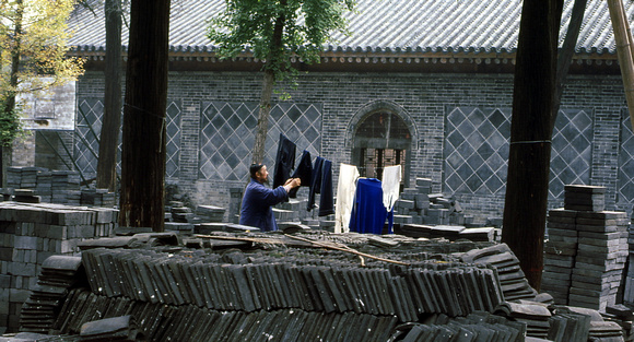 Daoist monk, going about his business among the construction
