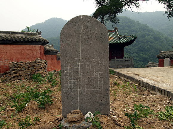 Stele, back side used as a chess board, re-erected for cosmetic reasons