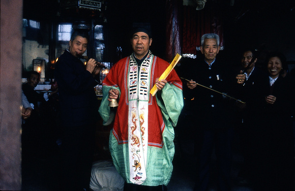 Daoist priest performing a ritual (with musicians)