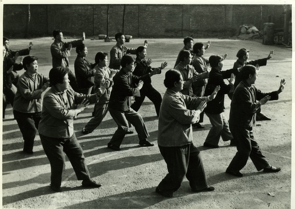 Workers at a textile factory in Tianjin doing shadow boxing (Taiji quan)